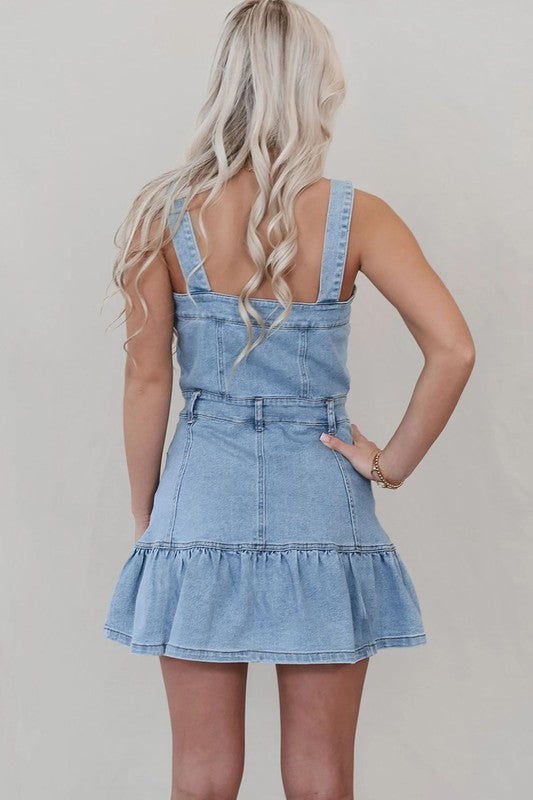 A tiered denim mini dress with button-down closure and pockets.