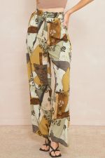 Printed high waisted wide leg pants featuring elastic drawstring waist. Pocket at sides.